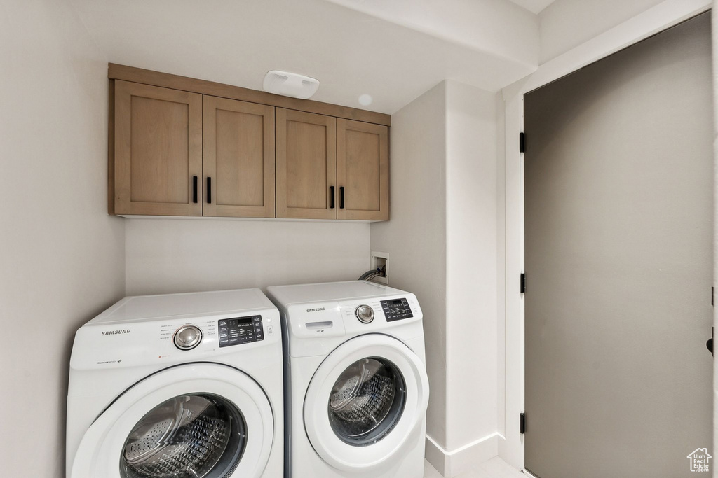 Laundry room with cabinets and washing machine and dryer