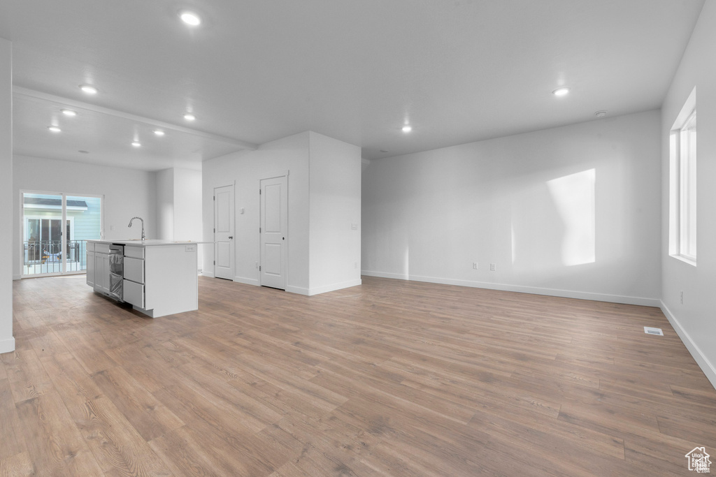 Unfurnished living room with light hardwood / wood-style floors