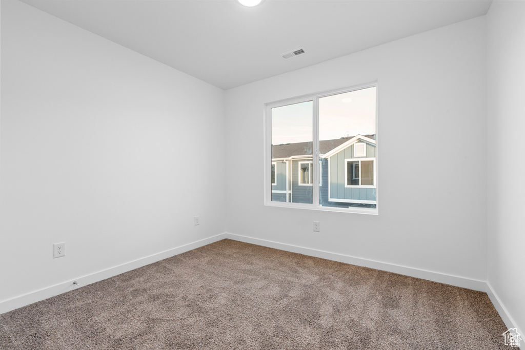 Unfurnished room featuring carpet