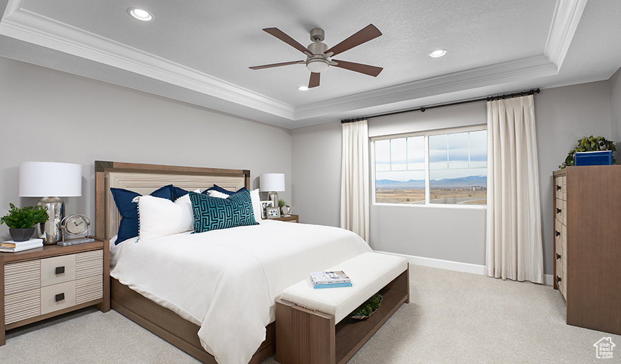 Carpeted bedroom with ceiling fan, a textured ceiling, a raised ceiling, and ornamental molding