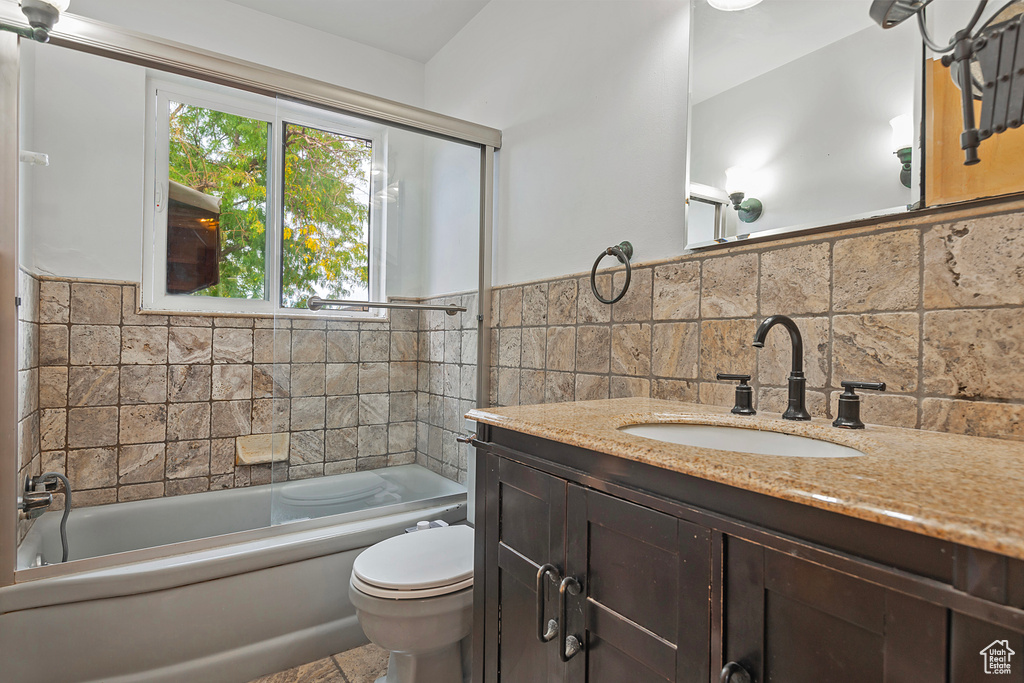 Full bathroom featuring shower / washtub combination, vanity, and toilet