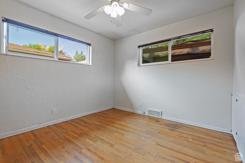 Spare room featuring ceiling fan and light hardwood / wood-style flooring