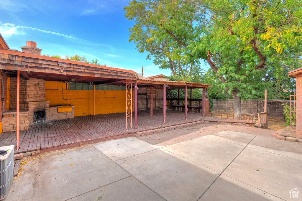 View of patio / terrace with central air condition unit and a wooden deck