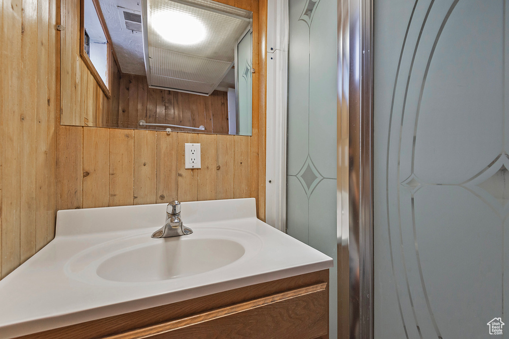 Bathroom with wooden walls and vanity