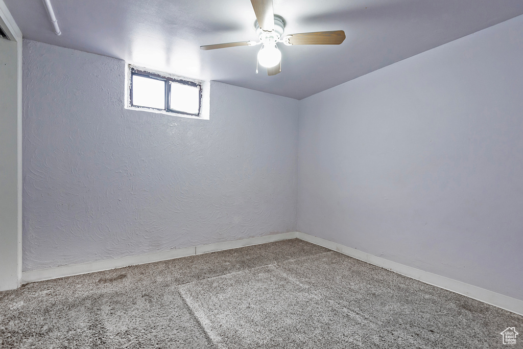 Spare room featuring ceiling fan and carpet floors