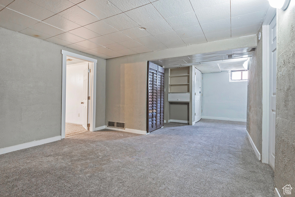 Basement featuring carpet