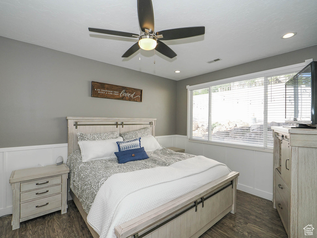 Bedroom with dark hardwood / wood-style flooring and ceiling fan