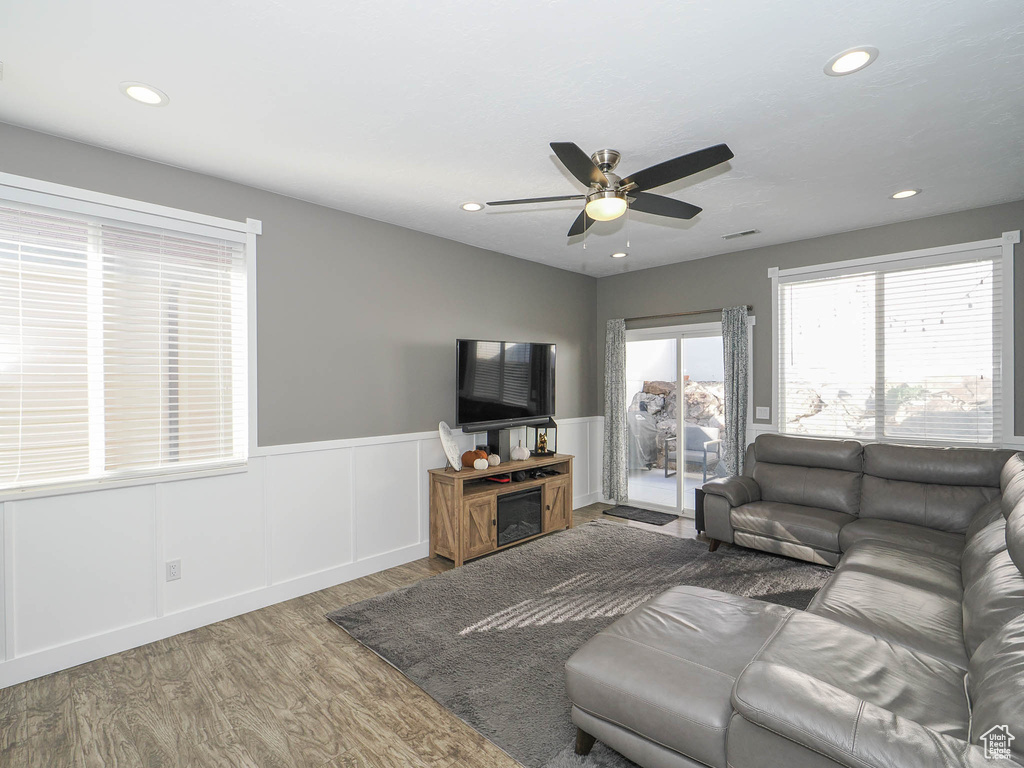 Living room featuring hardwood / wood-style flooring and ceiling fan