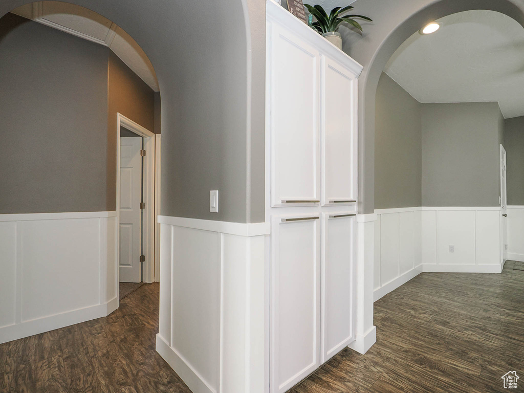 Hallway with dark wood-type flooring