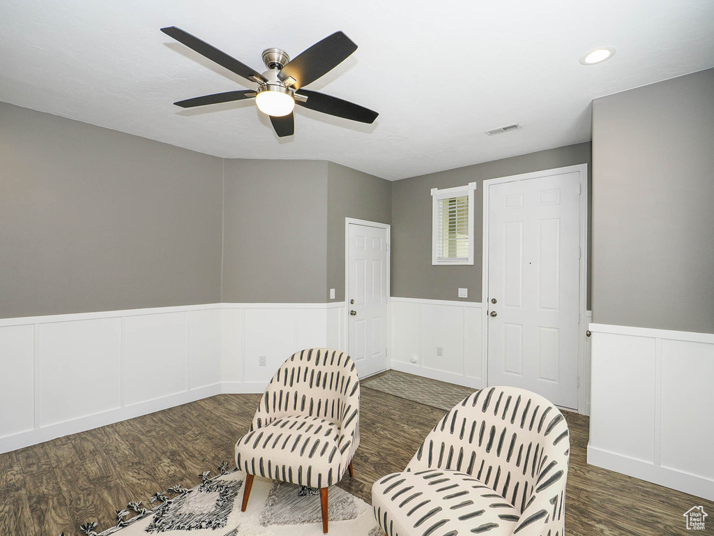 Sitting room featuring dark hardwood / wood-style flooring and ceiling fan