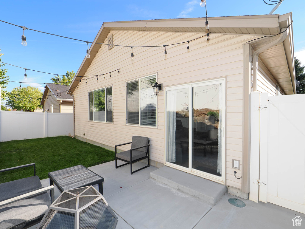 Back of property featuring a patio and a lawn