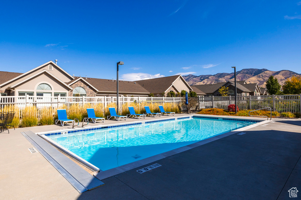 View of pool with a patio and a mountain view