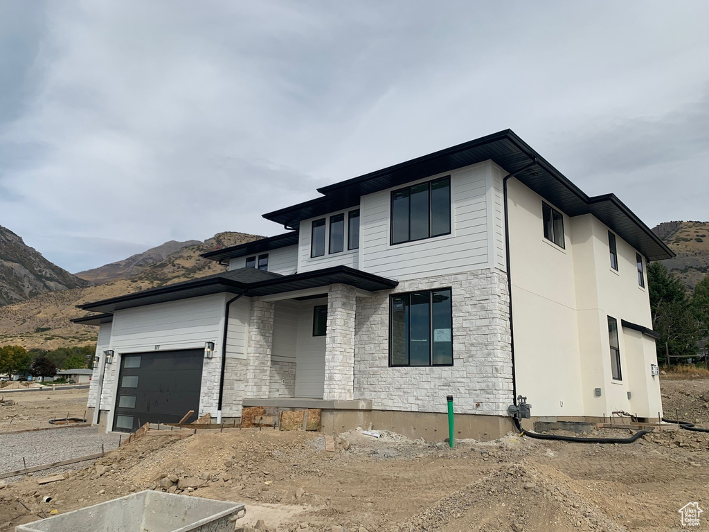 Prairie-style house featuring a mountain view and a garage