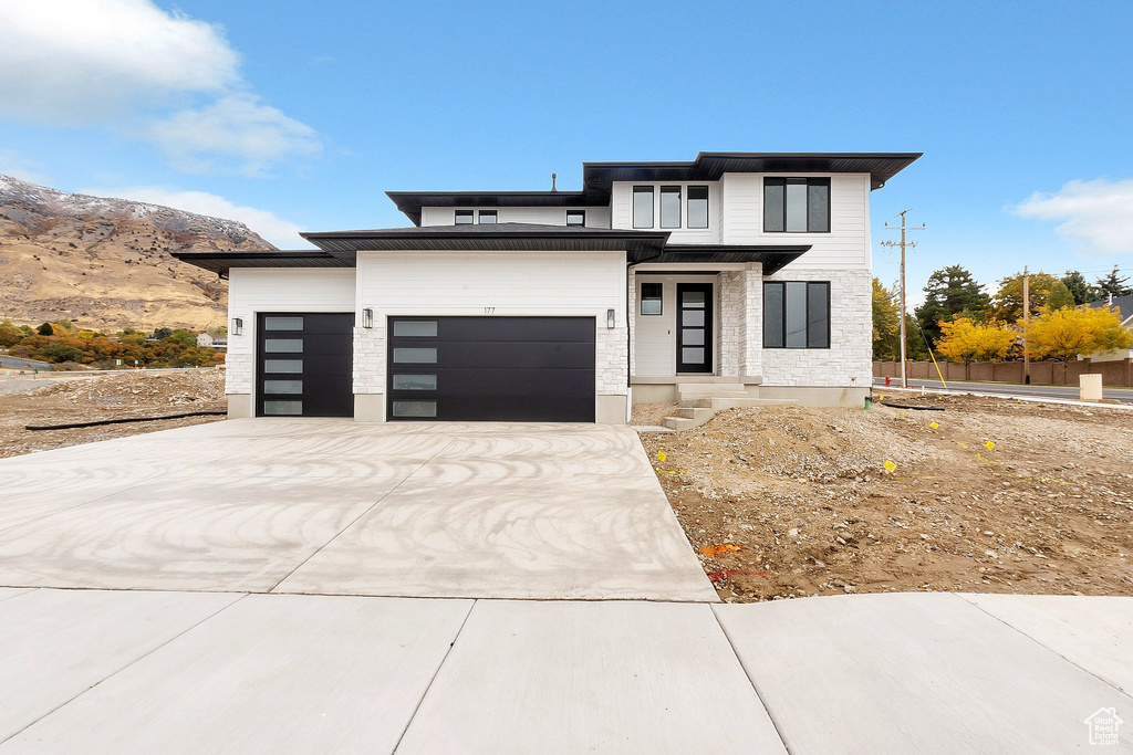 Prairie-style house with a mountain view and a garage