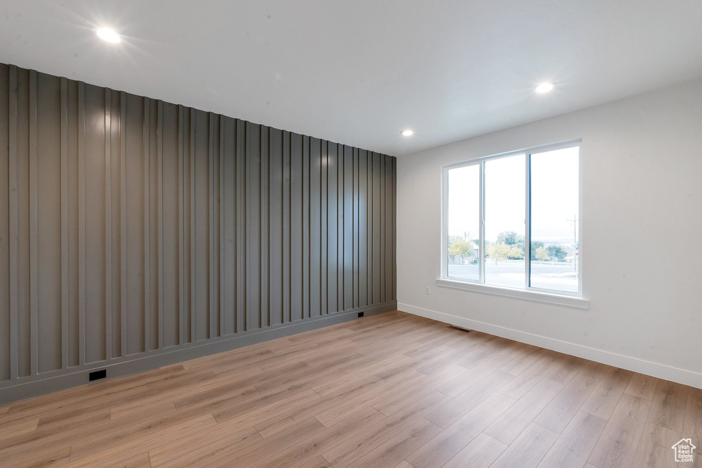 Unfurnished room with light wood-type flooring