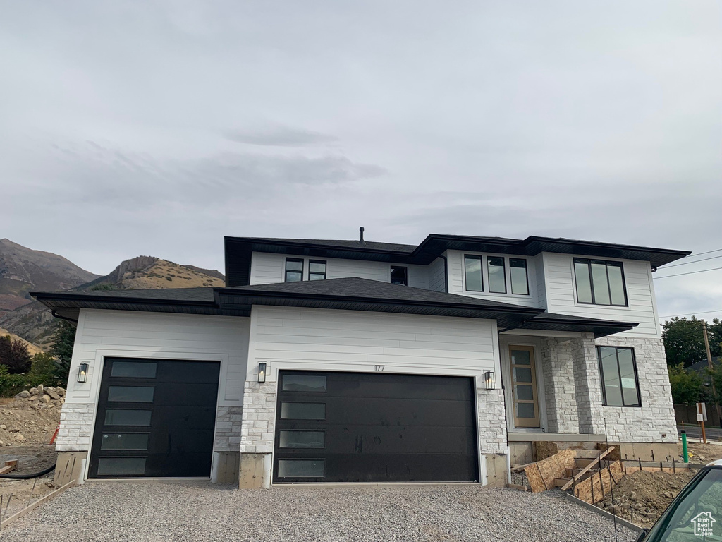 Prairie-style house with a mountain view and a garage