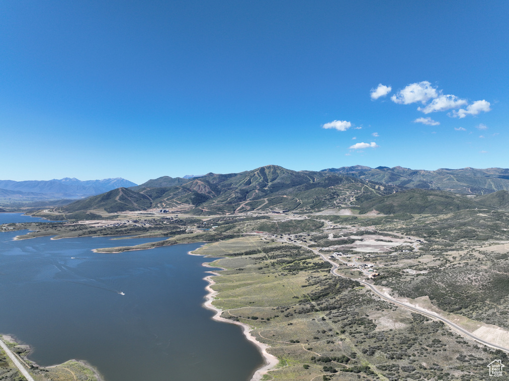 Drone / aerial view with a water and mountain view