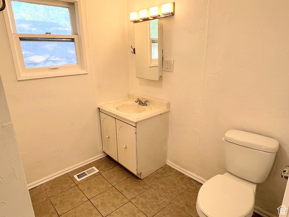 Bathroom with vanity, tile patterned flooring, and toilet