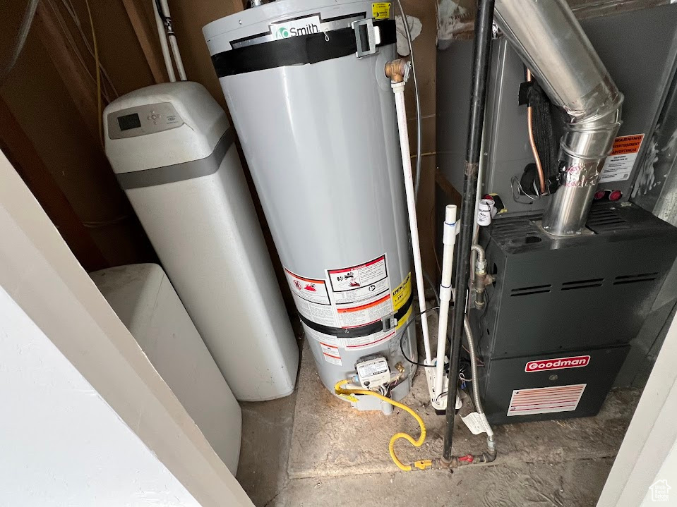 Utility room featuring gas water heater and heating unit