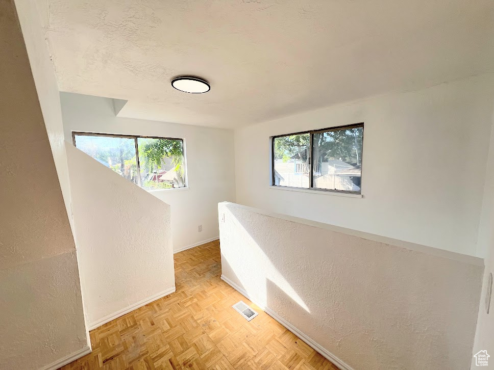 Corridor featuring light parquet floors