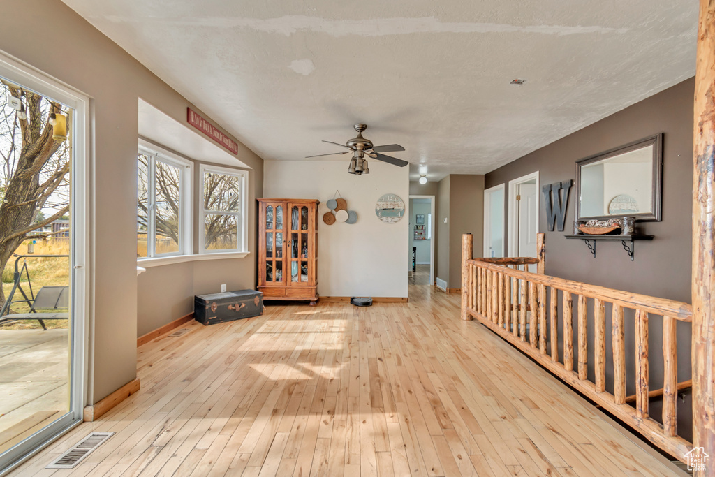 Interior space with light wood-type flooring and ceiling fan