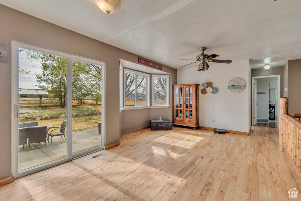 Interior space featuring light wood-type flooring and ceiling fan