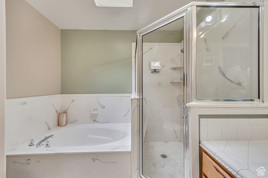 Bathroom with vanity and separate shower and tub