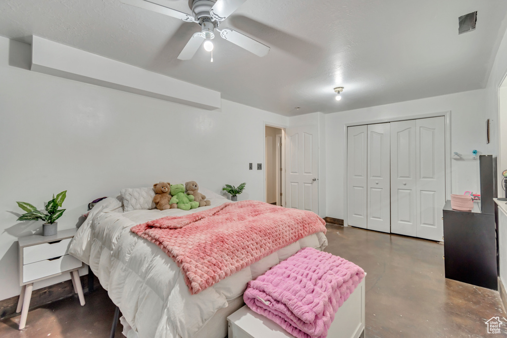 Bedroom with ceiling fan and a closet