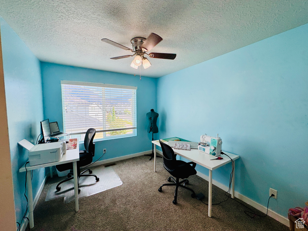 Office with ceiling fan, carpet, and a textured ceiling