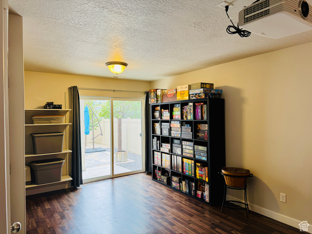 Miscellaneous room with dark hardwood / wood-style flooring and a textured ceiling