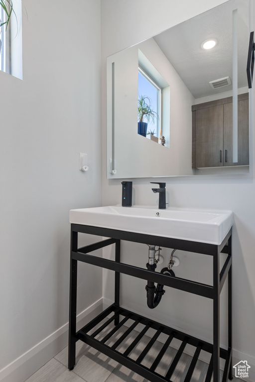 Bathroom with tile patterned flooring and vanity