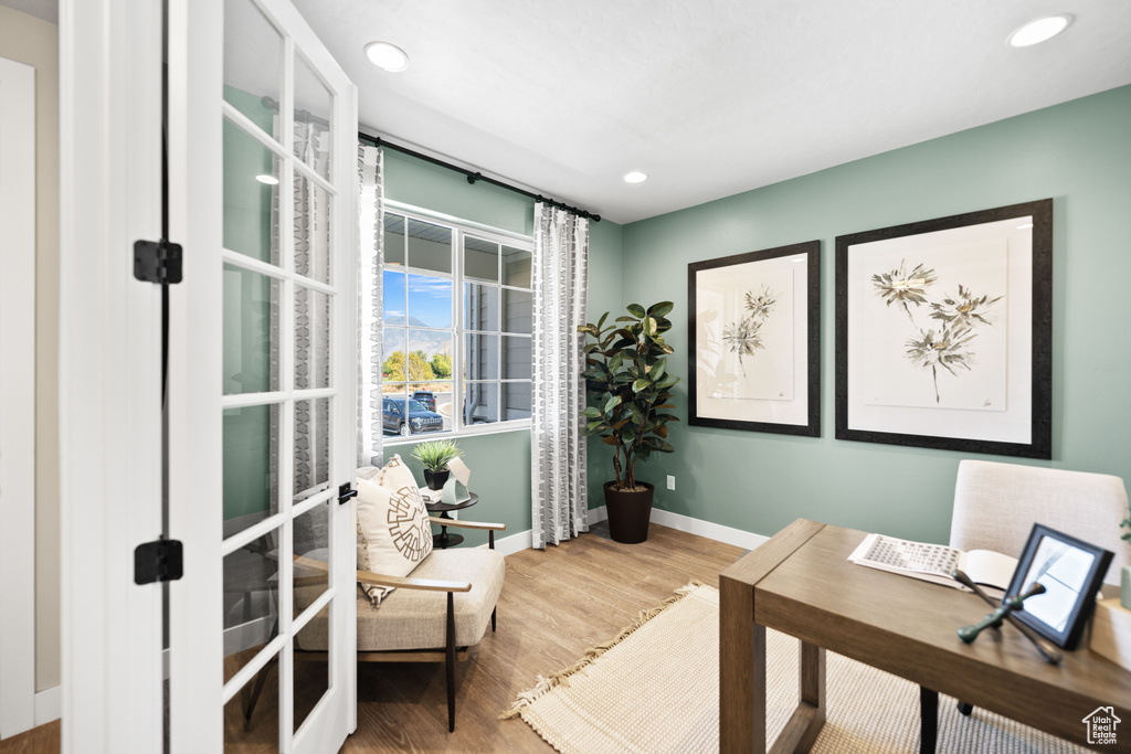 Office space with french doors and hardwood / wood-style floors