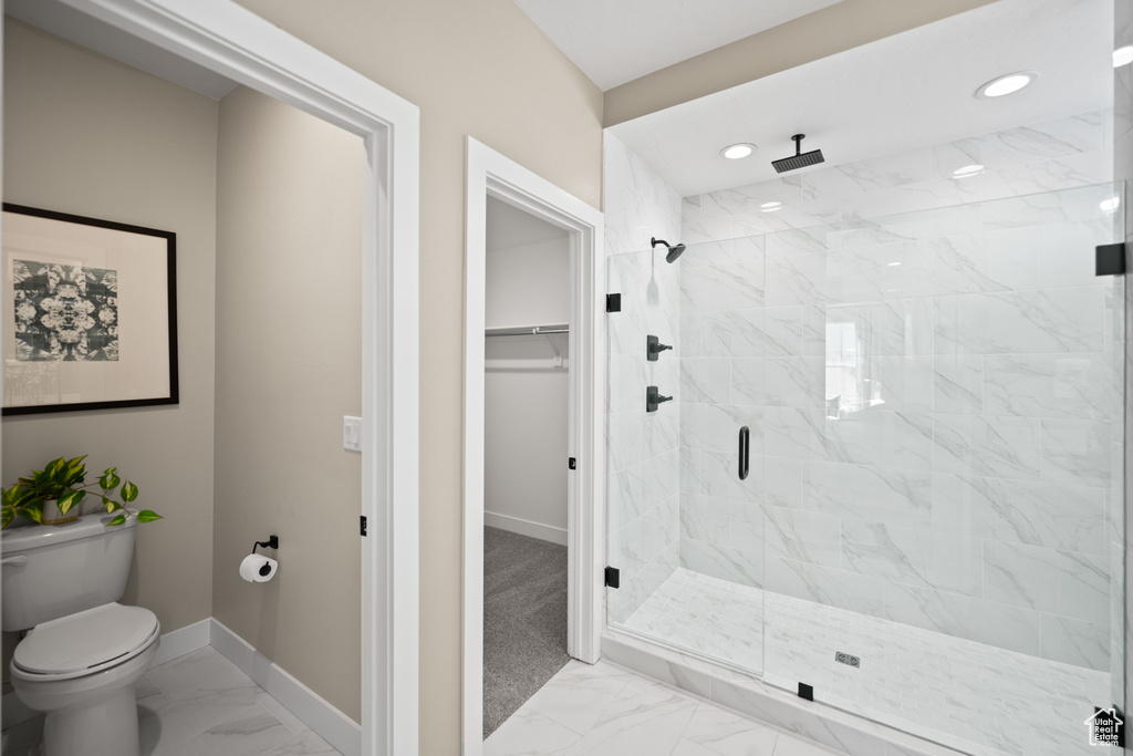 Bathroom featuring an enclosed shower and toilet