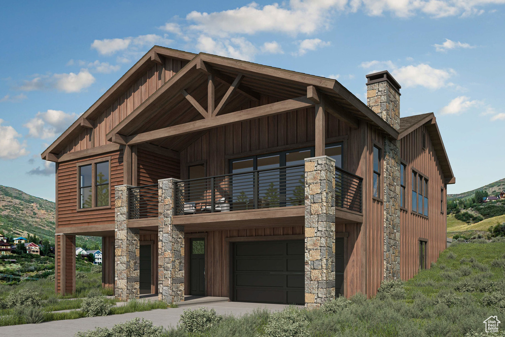 View of front of property featuring a balcony, a mountain view, and a garage