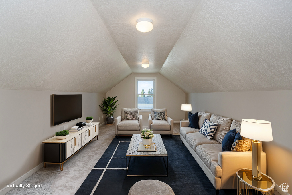 Living room featuring dark carpet, a textured ceiling, and vaulted ceiling