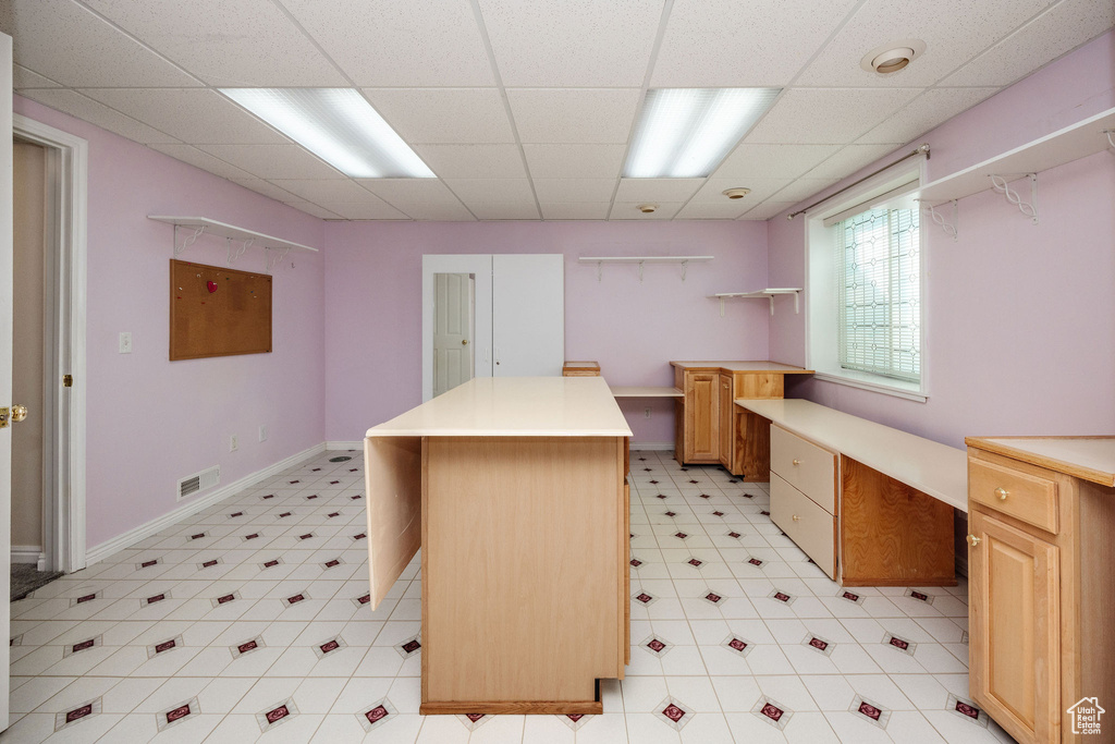 Office space with a paneled ceiling