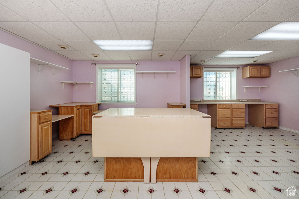 Kitchen featuring a drop ceiling and a center island