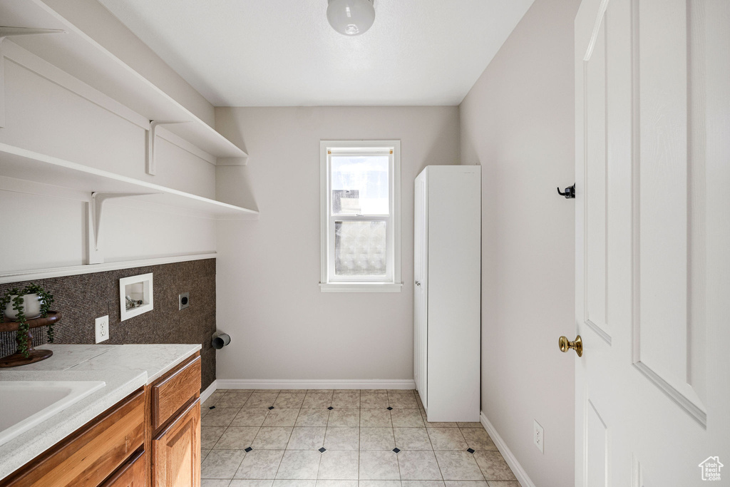 Laundry area featuring washer hookup, cabinets, and electric dryer hookup