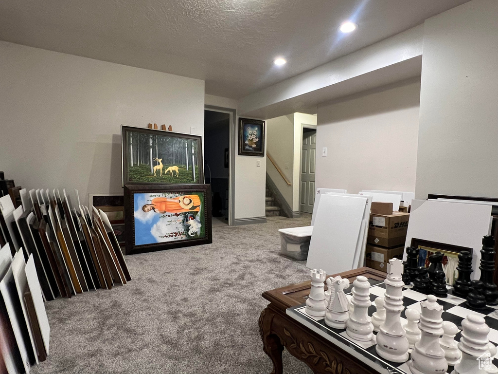 Carpeted living room featuring a textured ceiling