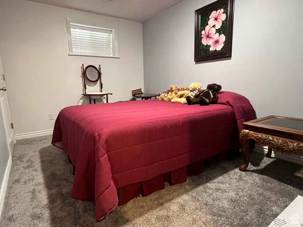 Bedroom featuring dark colored carpet