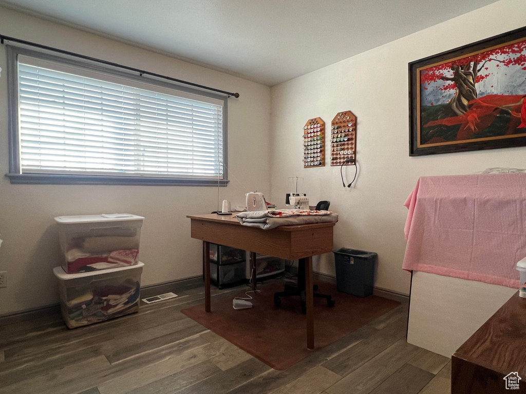 Home office featuring dark wood-type flooring and plenty of natural light