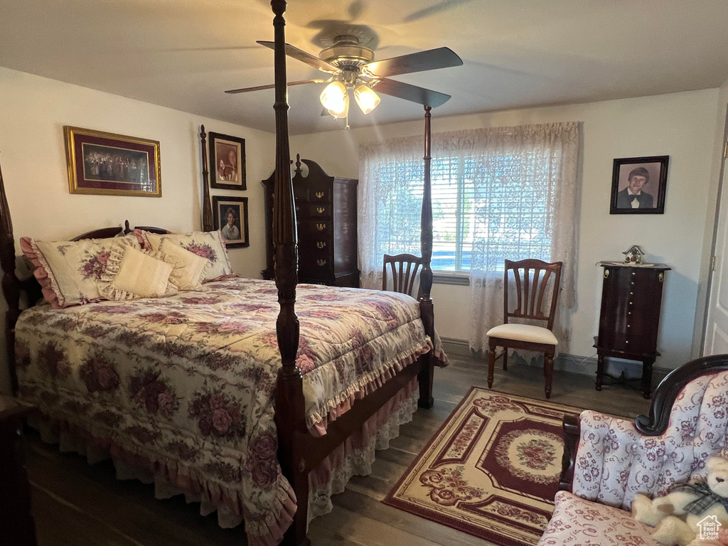 Bedroom featuring ceiling fan and hardwood / wood-style flooring