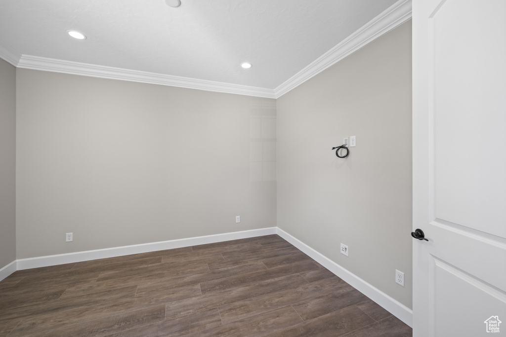 Unfurnished room featuring dark hardwood / wood-style floors and crown molding