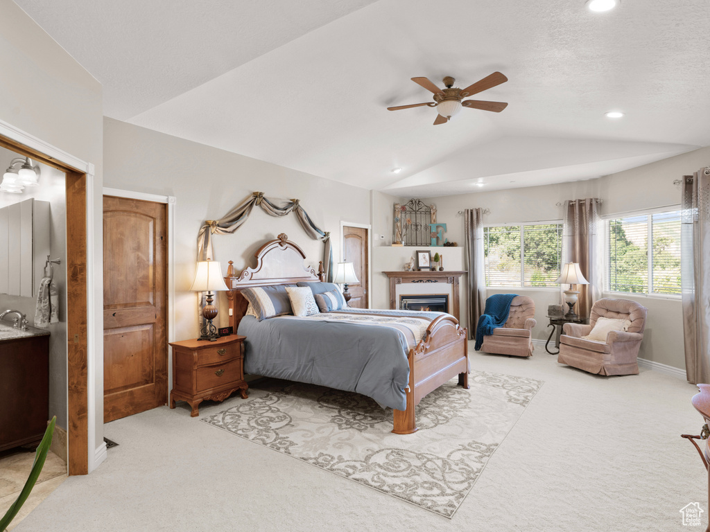 Bedroom with carpet floors, lofted ceiling, and ceiling fan