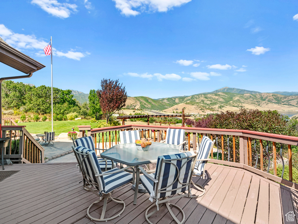 Deck with a lawn and a mountain view