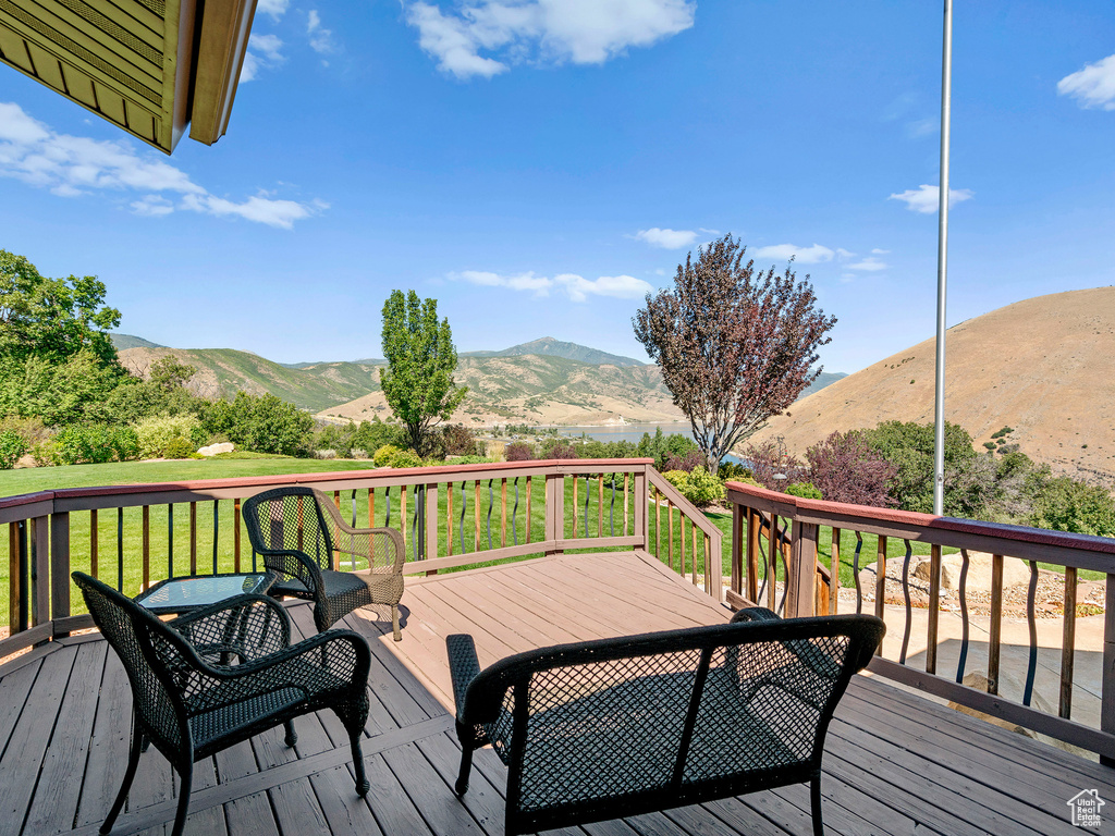 Deck featuring a mountain view and a yard