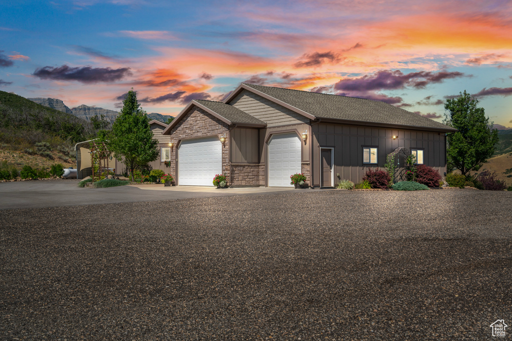 View of front of home featuring a mountain view and a garage