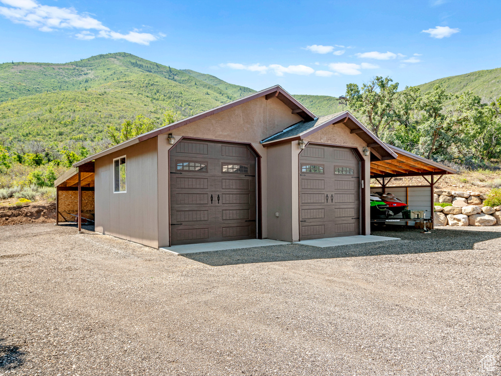 Garage with a mountain view and a carport