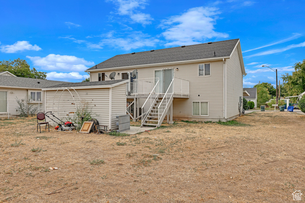 Rear view of house featuring a deck