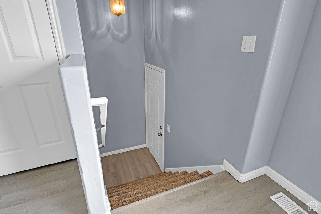 Stairway featuring wood-type flooring